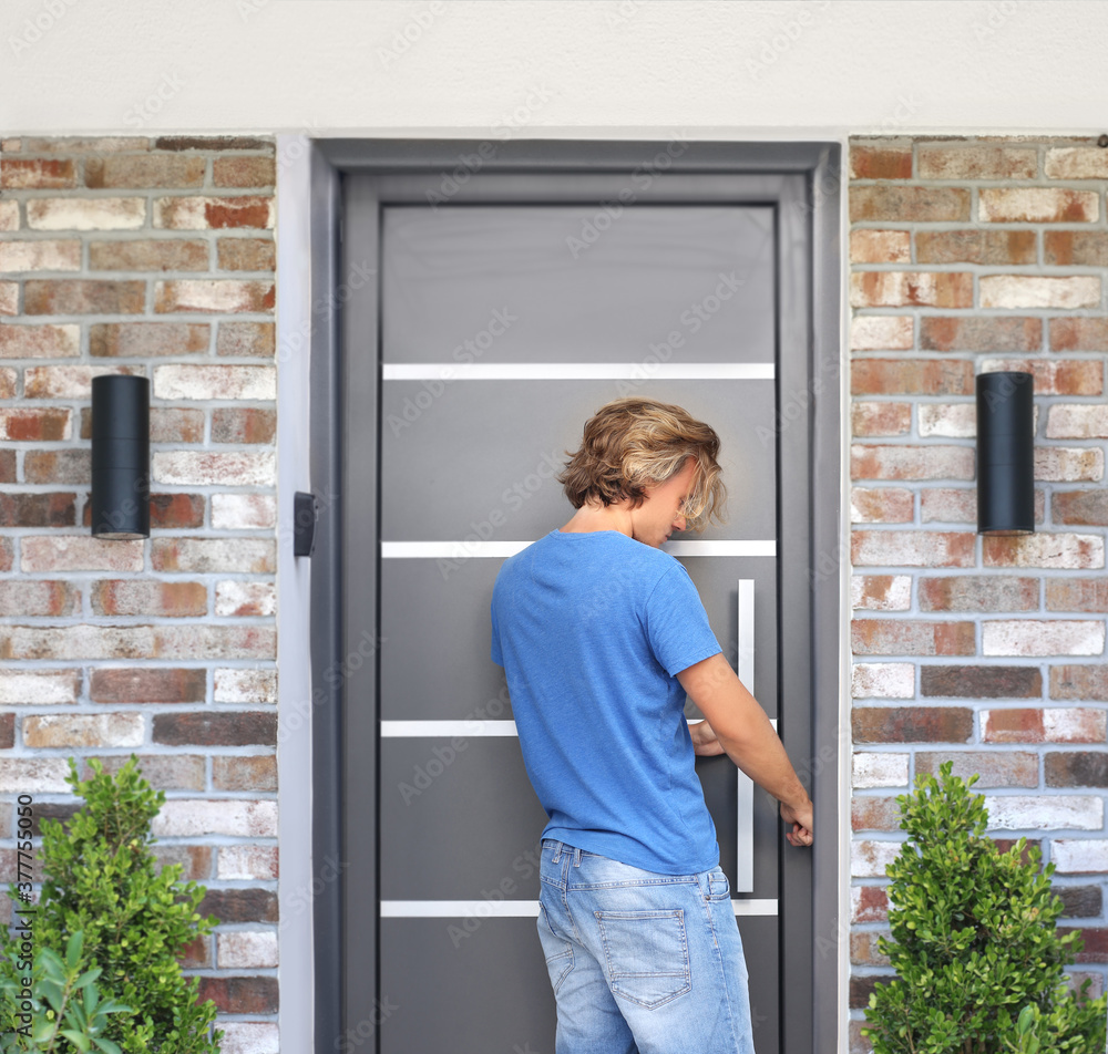 Man opening the door .Inviting the guests Man opening the door .Inviting the guests