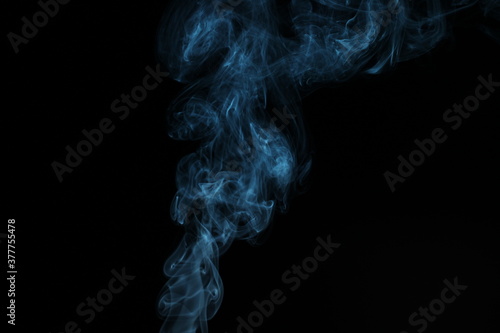 blue smoke from incense on a black background