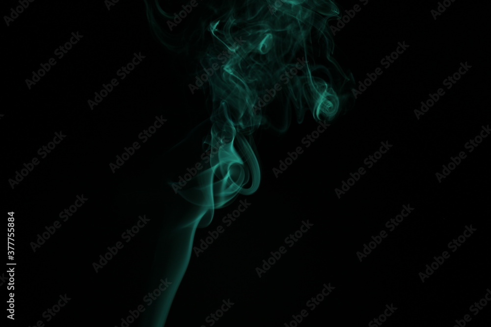 green smoke from incense on a black background green smoke from incense on a black background
