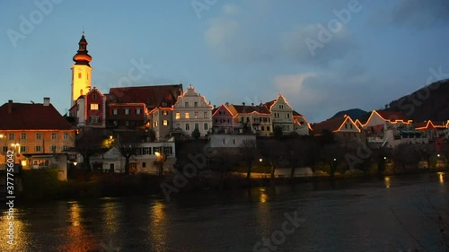 The charming old town of Frohnleiten with Christmas illumination and Mur river, in Styria, Austria, at night. photo