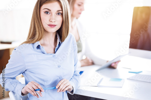 Business woman toned portrait in sunny office. Businesspeople or colleagues at meeting while sitting at the desk. Casual clothes style. Audit  tax or lawyer concept