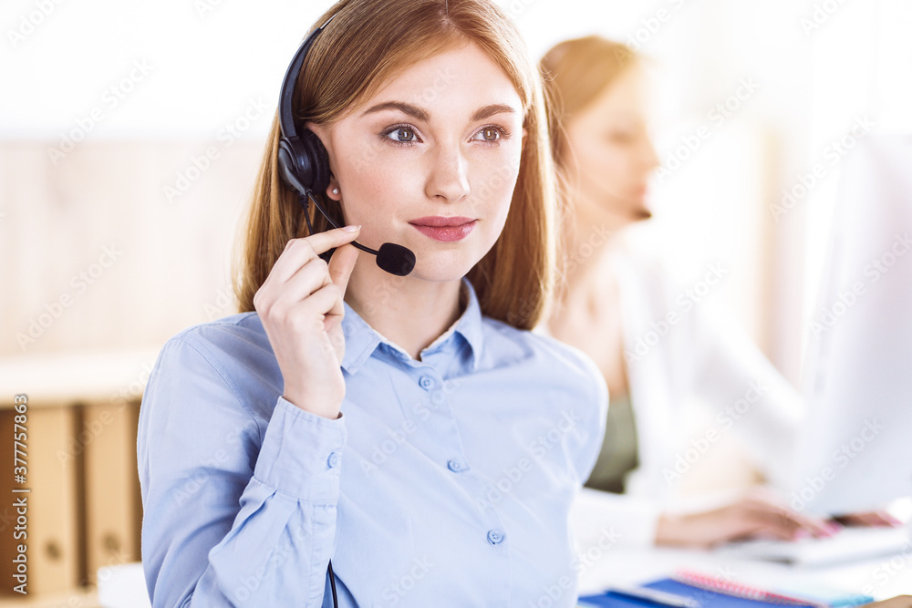 Toned portrait of call center operator at work. Group of people in a headset ready to help customers. Business concept Toned portrait of call center operator at work. Group of people in a headset ready to help customers. Business concept
