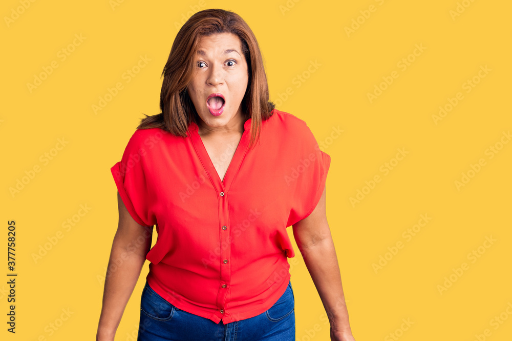 Middle age latin woman wearing casual clothes scared and amazed with open mouth for surprise, disbelief face Middle age latin woman wearing casual clothes scared and amazed with open mouth for surprise, disbelief face