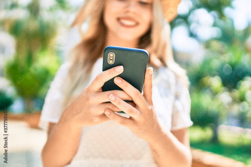 Young caucasian tourist girl smiling happy using smartphone at street of city.