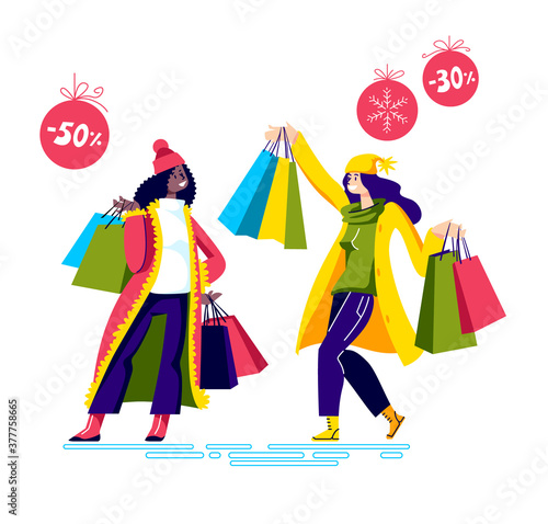 Happy girls holding shopping bags after holiday sales and special offers