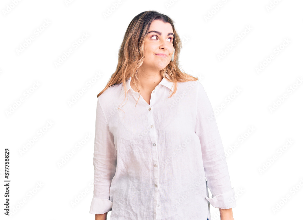 Young caucasian woman wearing casual clothes smiling looking to the side and staring away thinking. Young caucasian woman wearing casual clothes smiling looking to the side and staring away thinking.