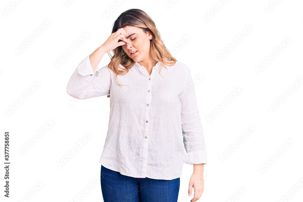Young caucasian woman wearing casual clothes tired rubbing nose and eyes feeling fatigue and headache. stress and frustration concept. Young caucasian woman wearing casual clothes tired rubbing nose and eyes feeling fatigue and headache. stress and frustration concept.