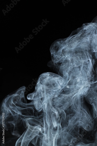 White smoke from incense on a black background