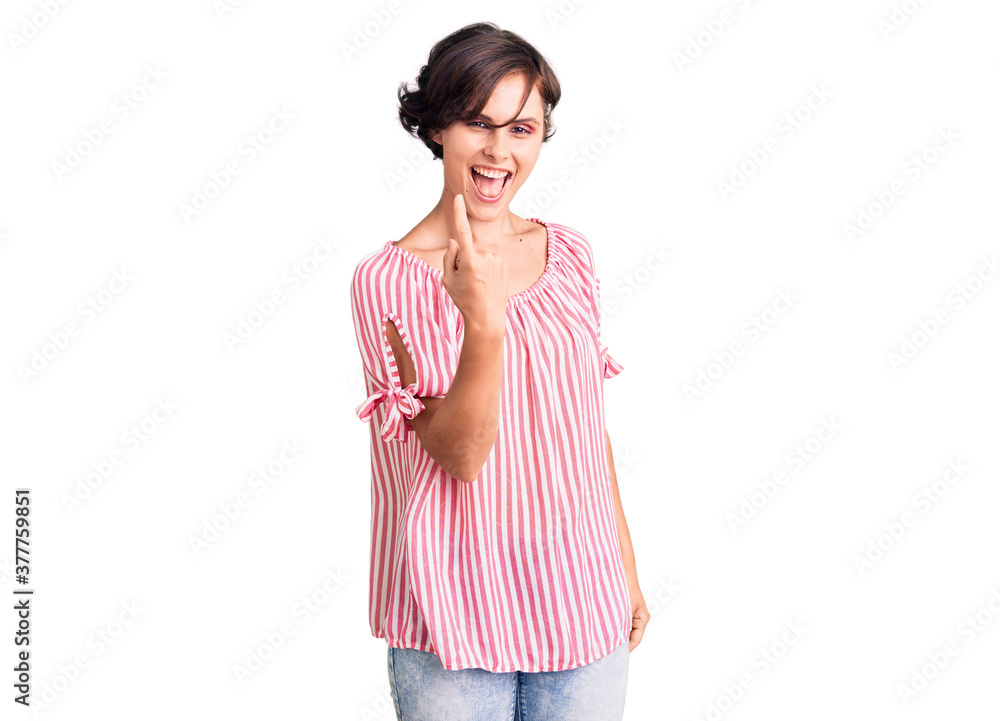 Beautiful young woman with short hair wearing casual summer clothes beckoning come here gesture with hand inviting welcoming happy and smiling Beautiful young woman with short hair wearing casual summer clothes beckoning come here gesture with hand inviting welcoming happy and smiling
