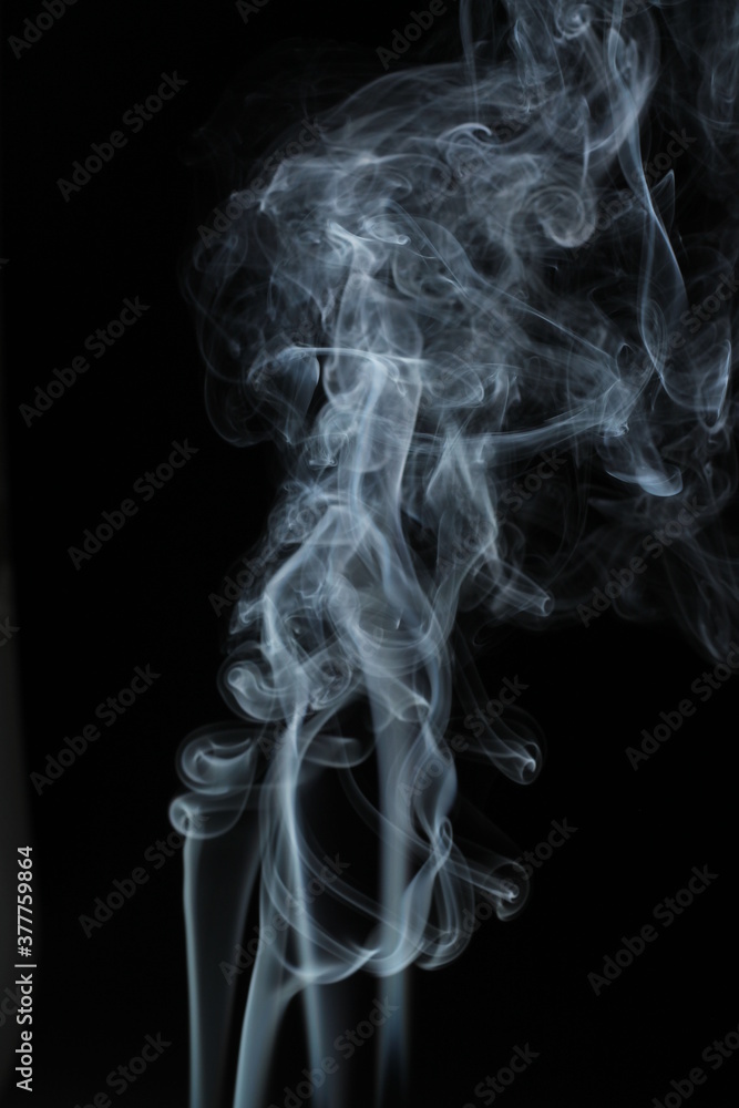 White smoke from incense on a black background White smoke from incense on a black background