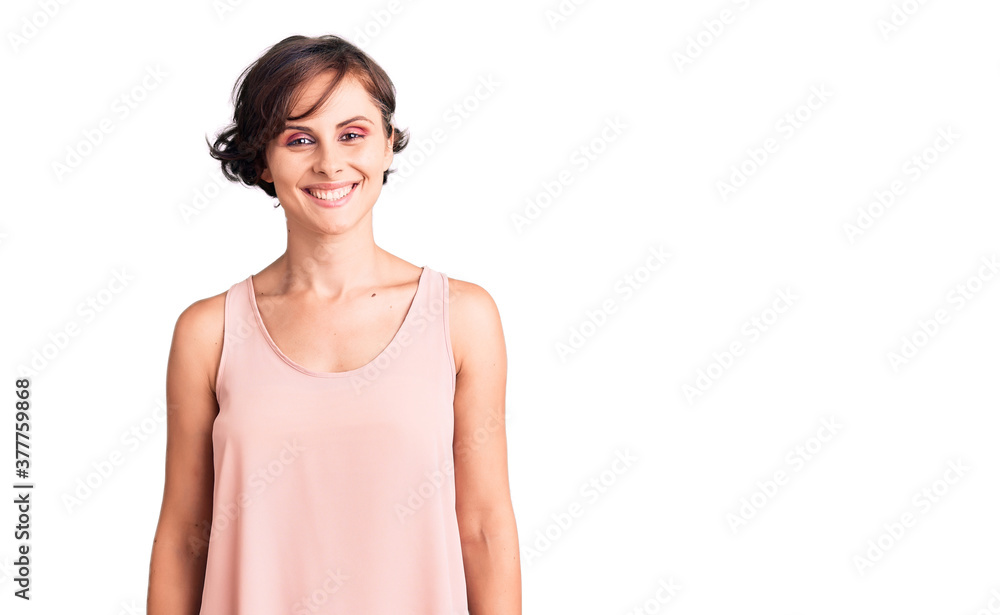 Beautiful young woman with short hair wearing casual style with sleeveless shirt with a happy and cool smile on face. lucky person. Beautiful young woman with short hair wearing casual style with sleeveless shirt with a happy and cool smile on face. lucky person.