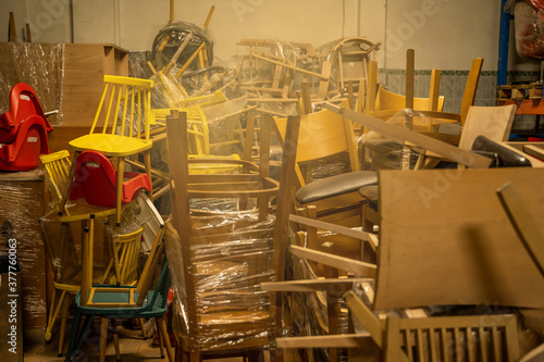 Fototapeta Photo of a furniture warehouse . A mountain of wooden chairs.