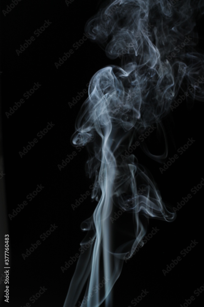 White smoke from incense on a black background White smoke from incense on a black background
