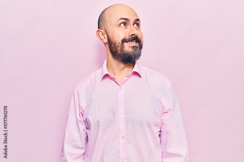 Young handsome man wearing business clothes looking away to side with smile on face, natural expression. laughing confident. Young handsome man wearing business clothes looking away to side with smile on face, natural expression. laughing confident.