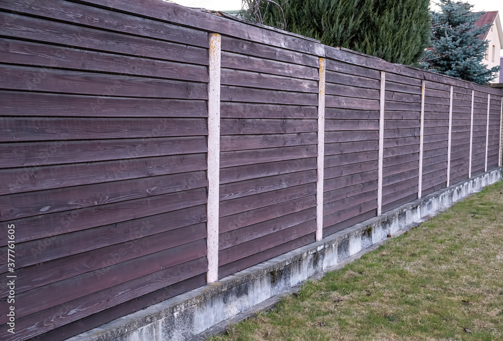 Brown wooden fence. Ptotection wooden fence. Outdoor Brown wooden fence. Ptotection wooden fence. Outdoor