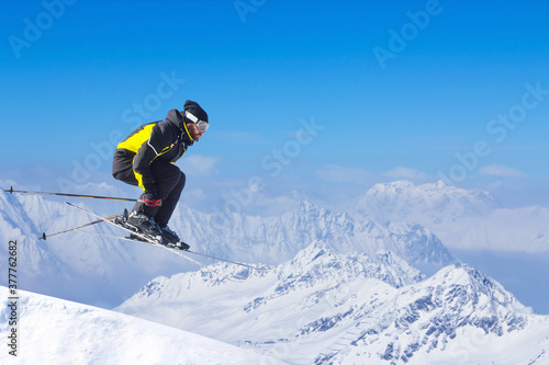 Jumping skier at mountains photo