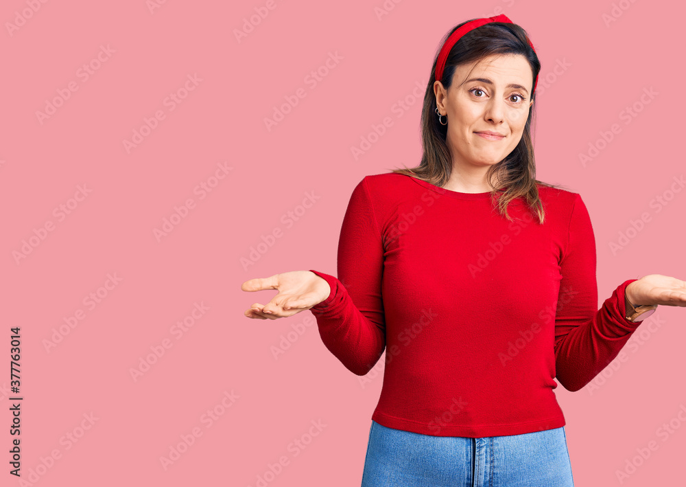 Young beautiful woman wearing casual clothes clueless and confused expression with arms and hands raised. doubt concept. Young beautiful woman wearing casual clothes clueless and confused expression with arms and hands raised. doubt concept.