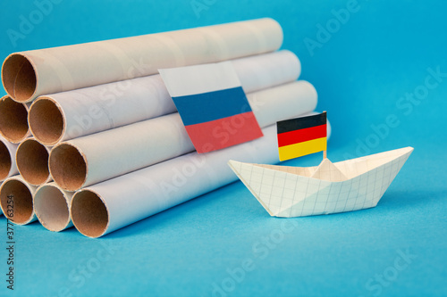 paper boat, gas pipes and the flag of russia, germany and the european union. abstract vision Nord Stream 2 Project  photo