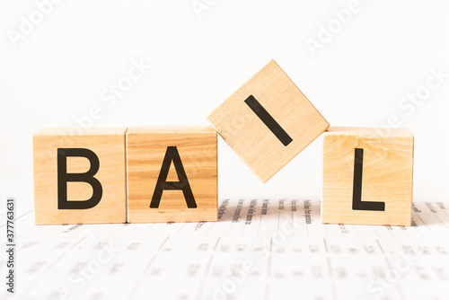 Word bail. Wooden small cubes with letters isolated on white background with copy space available