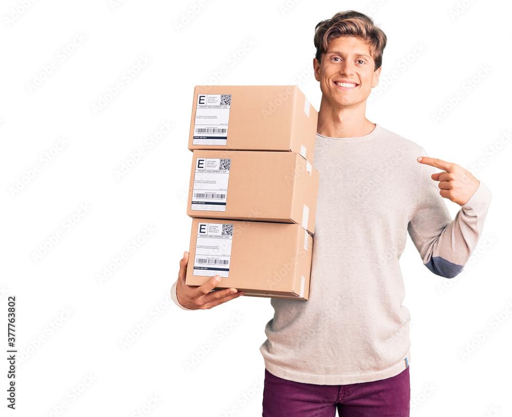 Young handsome man holding delivery package pointing finger to one self smiling happy and proud Young handsome man holding delivery package pointing finger to one self smiling happy and proud
