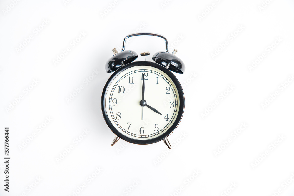 black alarm clock with white dial, 4 o'clock, isolate on white black alarm clock with white dial, 4 o'clock, isolate on white