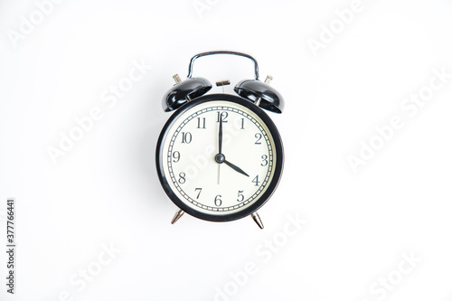 black alarm clock with white dial, 4 o'clock, isolate on white