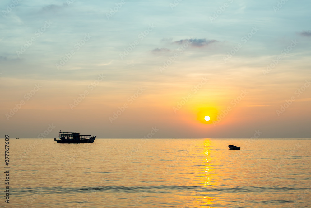 Sunset of the Sea with a ship and a boat. Thailand, Gulf of Thailand.