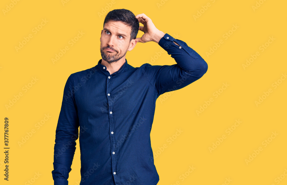 Young handsome man wearing casual shirt confuse and wondering about question. uncertain with doubt, thinking with hand on head. pensive concept. Young handsome man wearing casual shirt confuse and wondering about question. uncertain with doubt, thinking with hand on head. pensive concept.