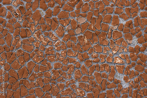 Texture of old cracked artificial leather. The surface of the dried leatherette with lots of cracks and pieces of brown material. Faux leather texture. Great for background and design. High resolution