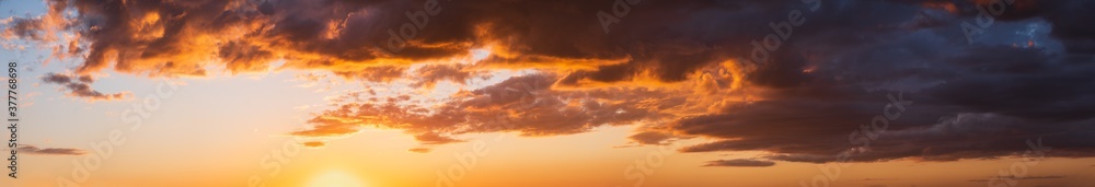 Summer sunset sky high resolution panorama with fleece colorful clouds. Evening dusk good weather natural background.