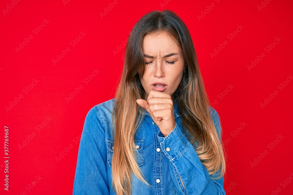 Beautiful caucasian woman wearing casual denim shirt feeling unwell and coughing as symptom for cold or bronchitis. health care concept. Beautiful caucasian woman wearing casual denim shirt feeling unwell and coughing as symptom for cold or bronchitis. health care concept.