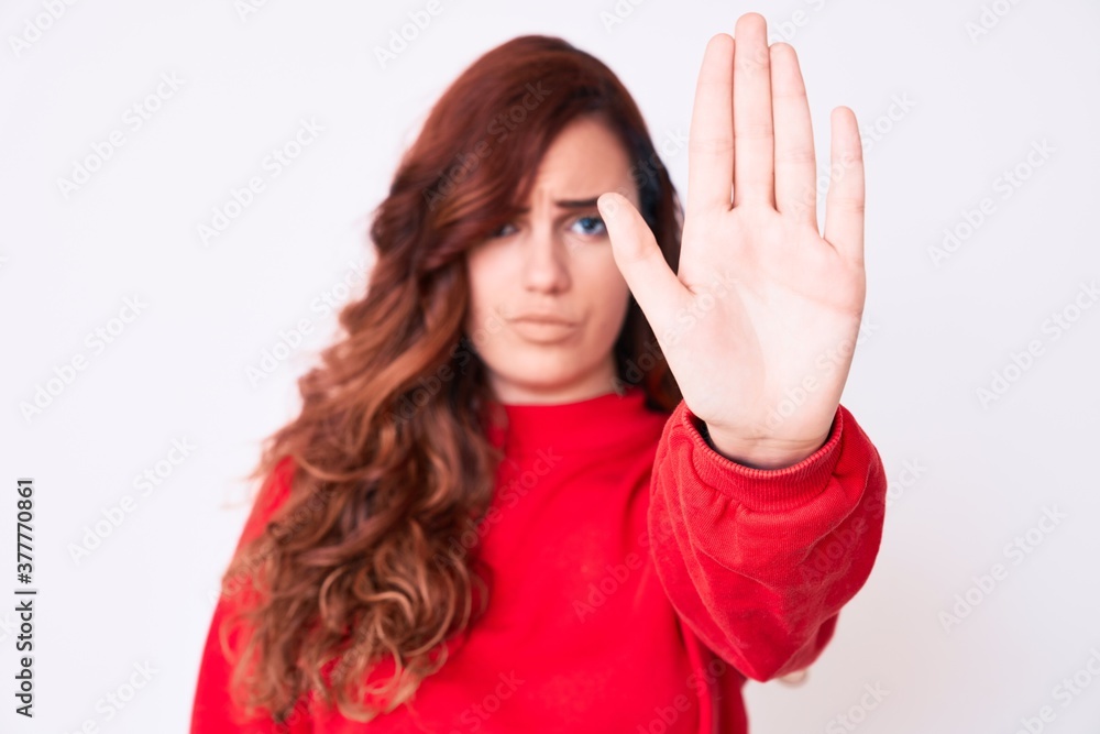 Young beautiful woman wearing casual clothes doing stop sing with palm of the hand. warning expression with negative and serious gesture on the face. Young beautiful woman wearing casual clothes doing stop sing with palm of the hand. warning expression with negative and serious gesture on the face.