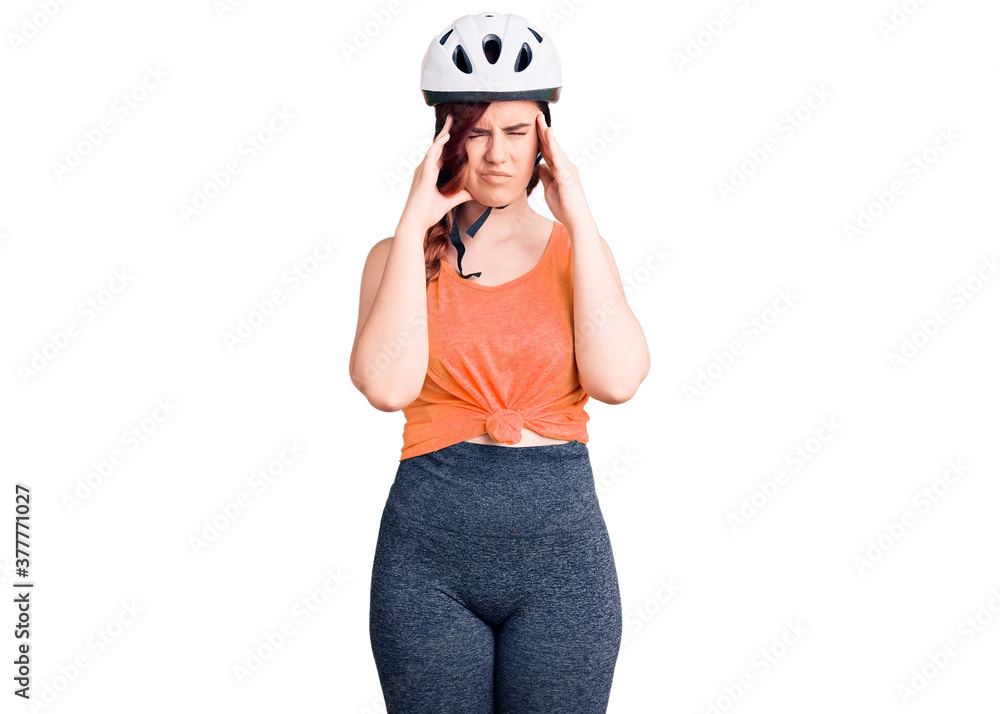 Young beautiful woman wearing bike helmet suffering from headache desperate and stressed because pain and migraine. hands on head. Young beautiful woman wearing bike helmet suffering from headache desperate and stressed because pain and migraine. hands on head.