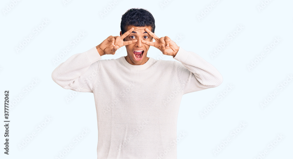 Young african amercian man wearing casual clothes doing peace symbol with fingers over face, smiling cheerful showing victory Young african amercian man wearing casual clothes doing peace symbol with fingers over face, smiling cheerful showing victory