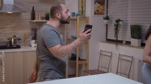 Wallpaper Mural Cheated man yelling at wife and hitting her. Jealous husband angry, frustrated, offended and irritated accusing woman of infidelity arguing her with messages on smartphone screaming desperate Torontodigital.ca