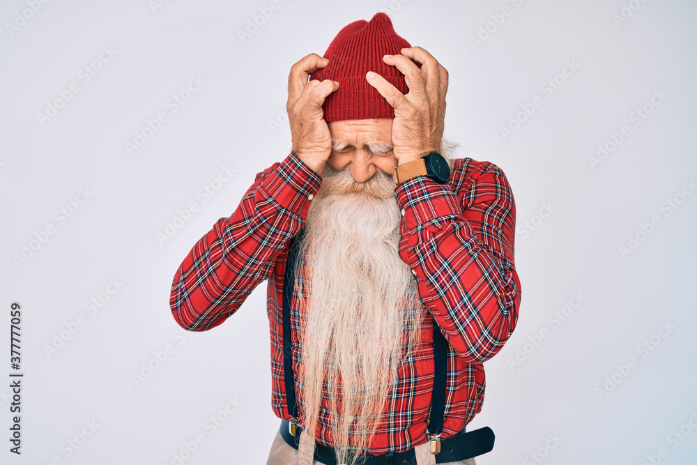 Φωτογραφία Old senior man with grey hair and long beard wearing hipster look with wool cap suffering from headache desperate and stressed because pain and migraine