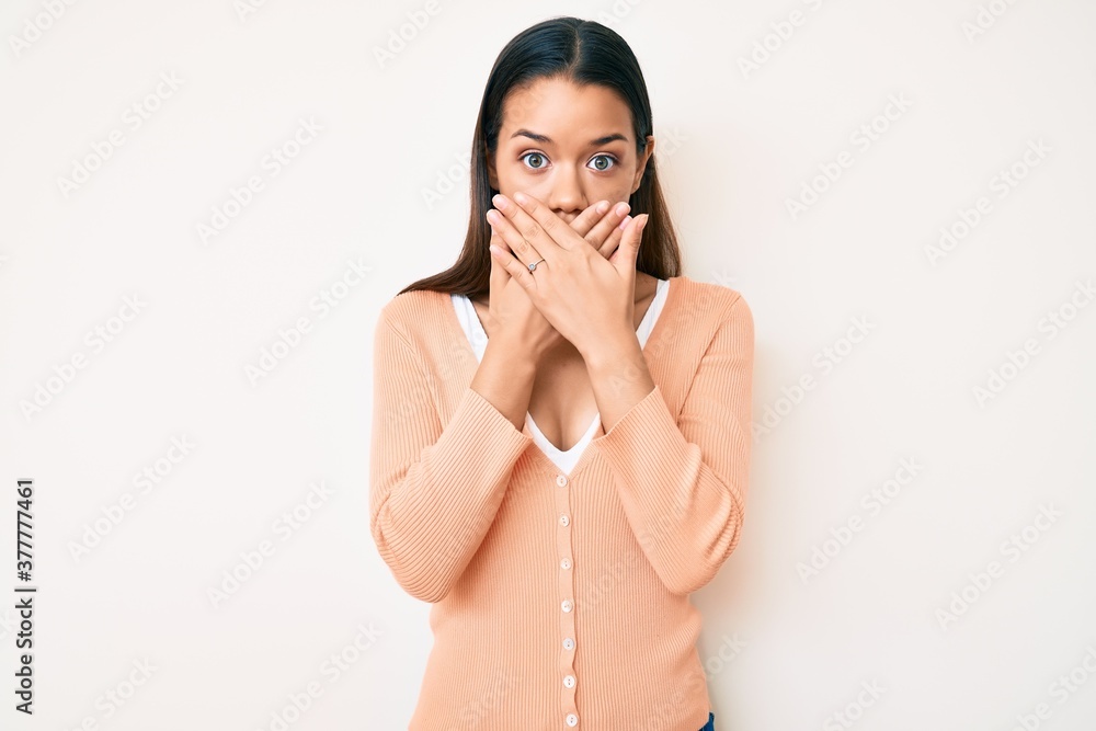 Young beautiful latin girl wearing casual clothes shocked covering mouth with hands for mistake. secret concept. Young beautiful latin girl wearing casual clothes shocked covering mouth with hands for mistake. secret concept.