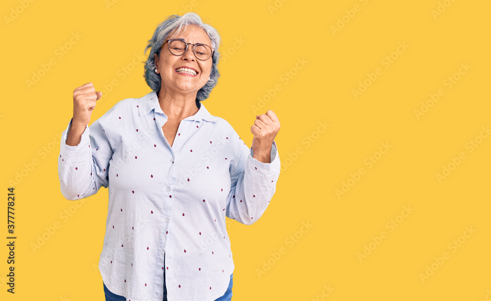 Φωτογραφία Senior woman with gray hair wearing casual business clothes and glasses very happy and excited doing winner gesture with arms raised, smiling and screaming for success