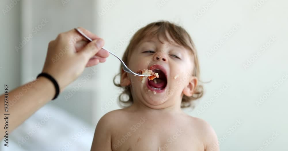 Baby boy refusing food. Child infant not wanting spoon Baby boy refusing food. Child infant not wanting spoon