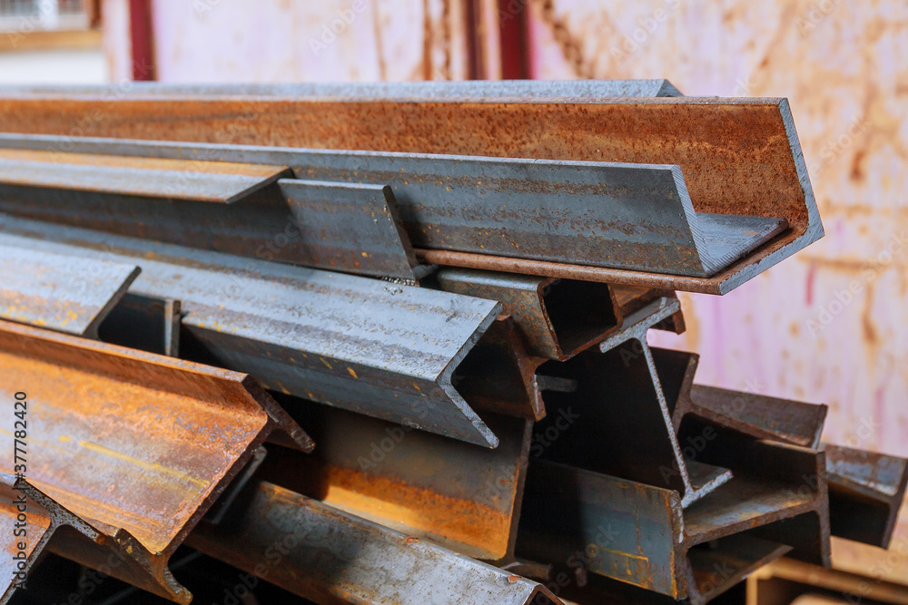 Foto de Stack of steel and rusty rail profiles. Rail crosssections