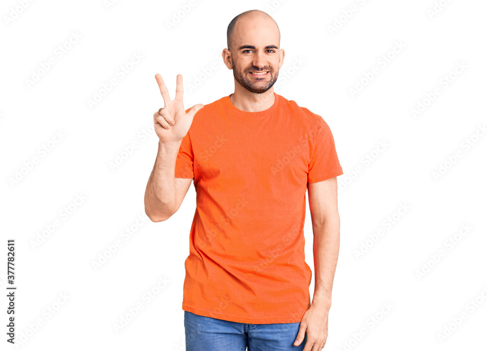 Young handsome man wering casual t shirt showing and pointing up with fingers number three while smiling confident and happy. Young handsome man wering casual t shirt showing and pointing up with fingers number three while smiling confident and happy.