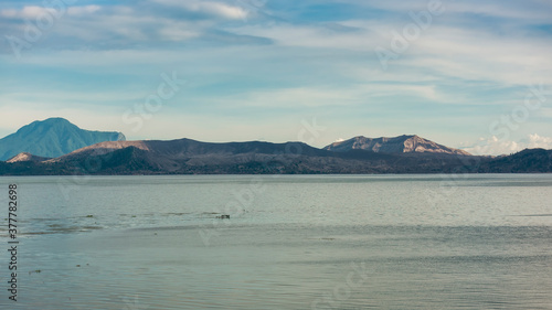 Taal volcano and lake, part of a massive caldera. Mt. Maculot in the left of picture. Late afternoon shot. photo