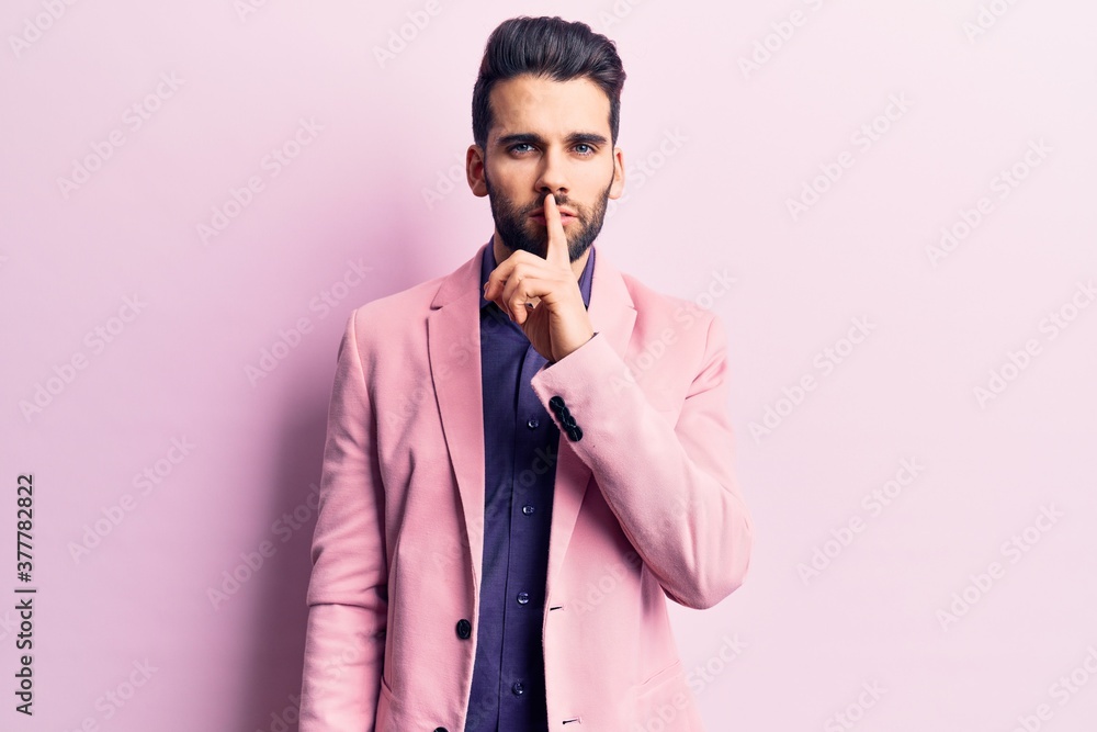 Young handsome man with beard wearing elegant jacket asking to be quiet with finger on lips. silence and secret concept. Young handsome man with beard wearing elegant jacket asking to be quiet with finger on lips. silence and secret concept.
