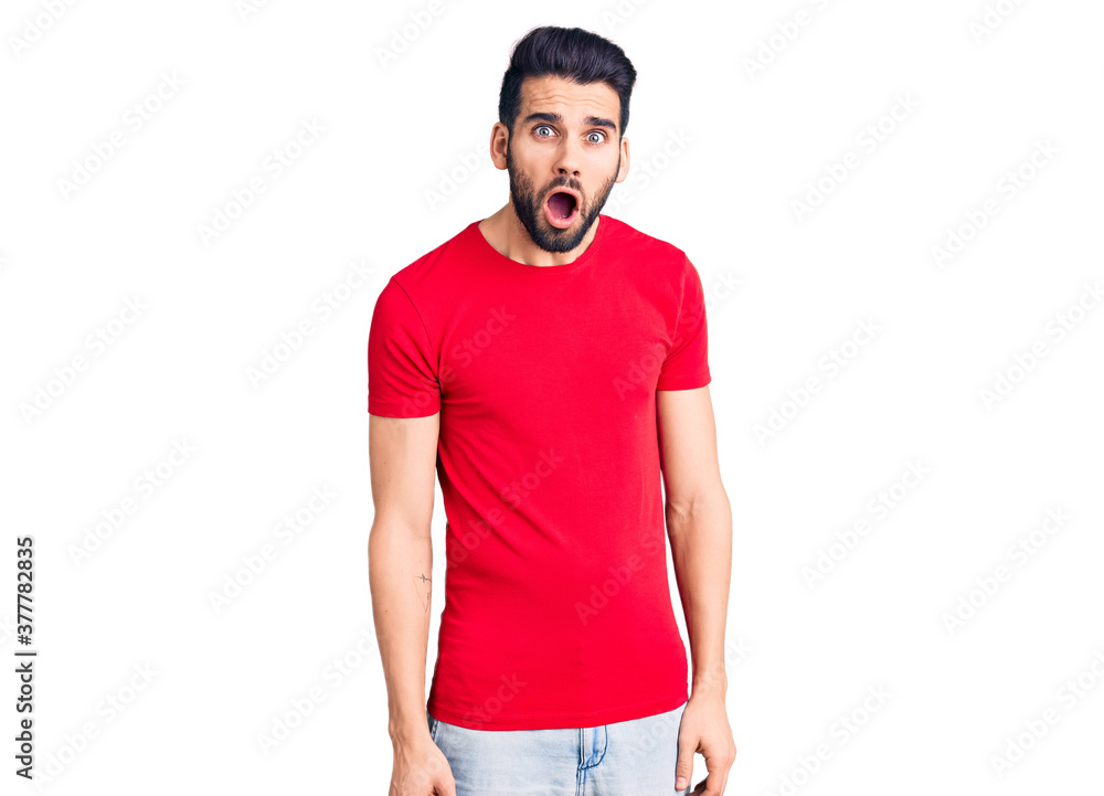 Young handsome man with beard wearing casual t-shirt afraid and shocked with surprise expression, fear and excited face. Young handsome man with beard wearing casual t-shirt afraid and shocked with surprise expression, fear and excited face.