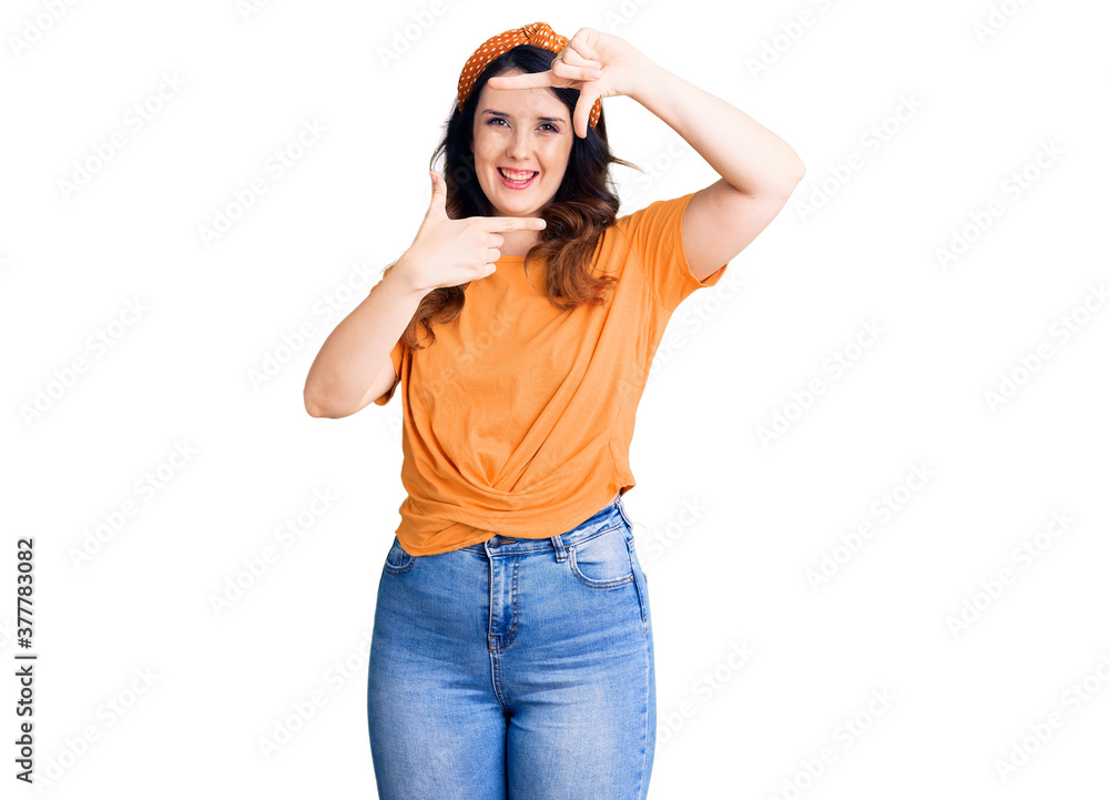 Beautiful young brunette woman wearing casual clothes smiling making frame with hands and fingers with happy face. creativity and photography concept. Beautiful young brunette woman wearing casual clothes smiling making frame with hands and fingers with happy face. creativity and photography concept.