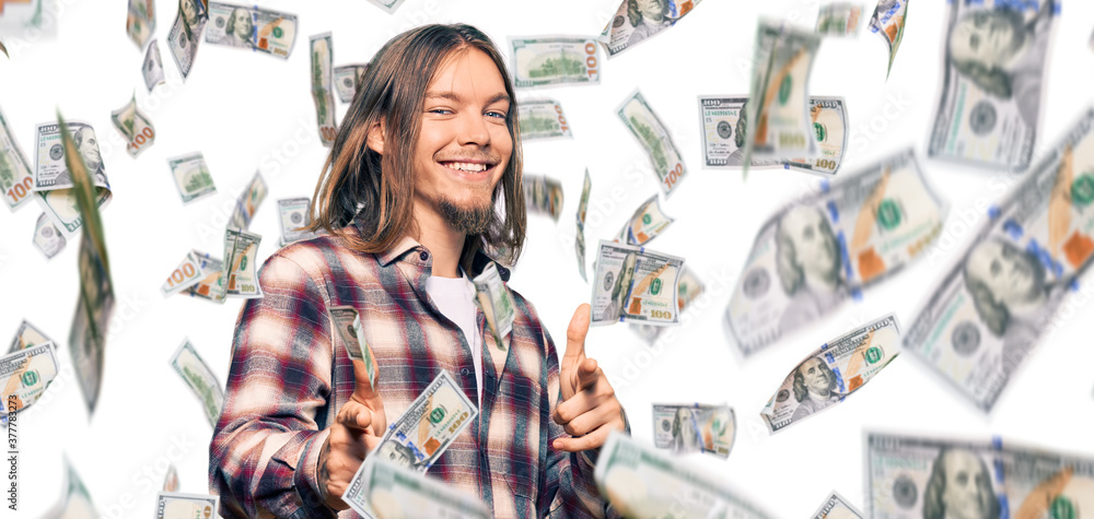 Handsome caucasian man with long hair wearing hipster shirt pointing fingers to camera with happy and funny face. good energy and vibes. Handsome caucasian man with long hair wearing hipster shirt pointing fingers to camera with happy and funny face. good energy and vibes.