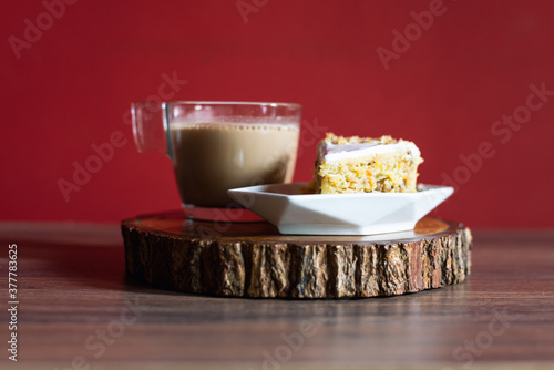 Carrot cake on wooden at home with coffee latte