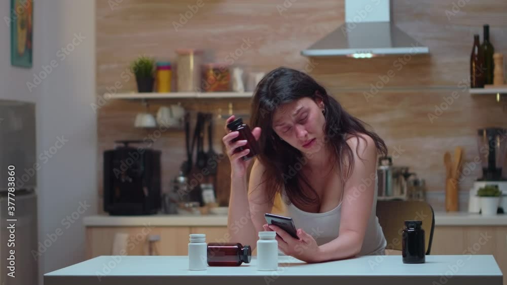 Woman with dizziness searching on the phone medical treatment. Stressed tired unhappy worried unwell wife suffering of migraine, depression, disease and anxiety feeling exhausted with allergy symptoms Woman with dizziness searching on the phone medical treatment. Stressed tired unhappy worried unwell wife suffering of migraine, depression, disease and anxiety feeling exhausted with allergy symptoms