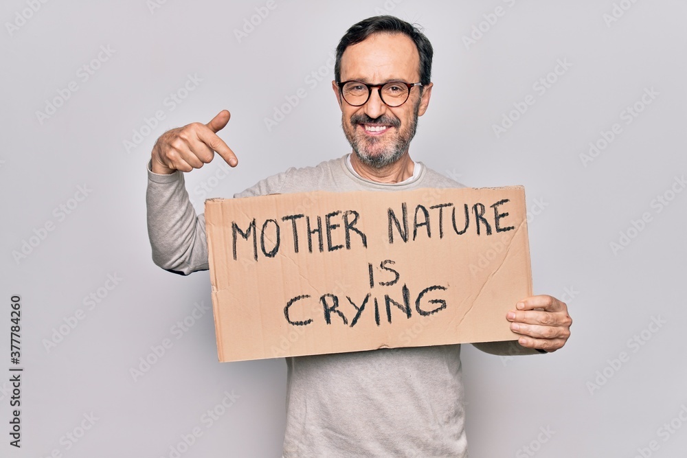 Middle age man asking for environment holding banner with mother nature is crying message smiling happy pointing with hand and finger Middle age man asking for environment holding banner with mother nature is crying message smiling happy pointing with hand and finger