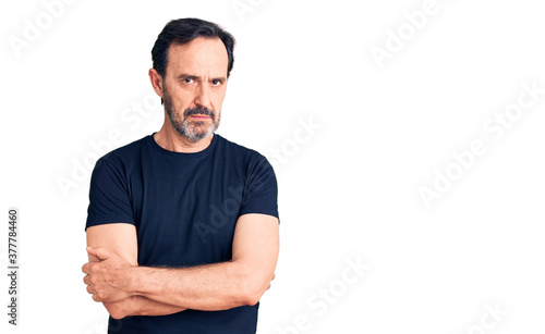 Middle age handsome man wearing casual t-shirt skeptic and nervous, disapproving expression on face with crossed arms. negative person.
